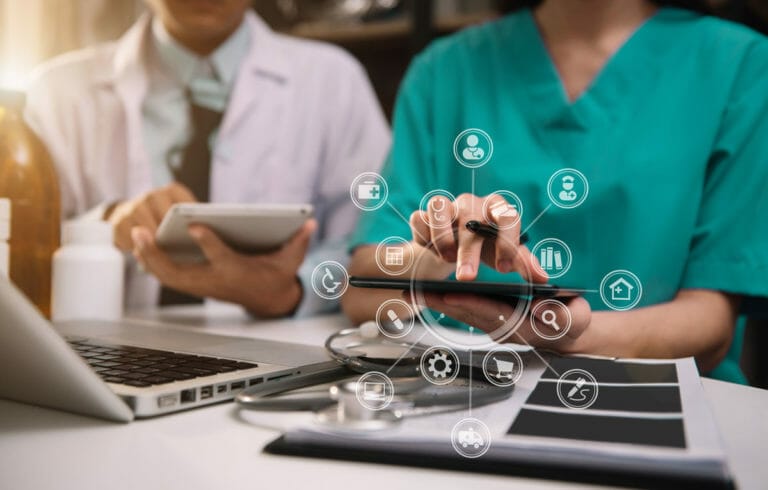 Medical professionals working on a computer